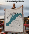 Man holding a woven blanket with Lake Marble Falls, Texas, and a compass design.