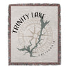 Woven blanket with Trinity Lake outline, compass rose, and text.