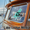Turquoise "Tiorati Life" sticker on a boat window, "Lake Lodge Media" text below.