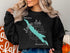 Black sweatshirt with "Beautiful Lacamas Lake Washington" and a compass rose.