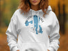 White hoodie with blue Yellowstone Lake map graphic and compass detail, reads "Wyoming".