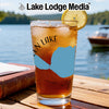 Iced tea in a tall glass with a lemon slice, featuring a map graphic and "Lake Lodge Media" logo.
