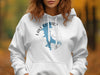 White hoodie with "Lake Quivira Kansas" graphic featuring a blue silhouette map and compass.