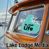 Teal St. Clair Life sticker on a boat window over Lake Lodge Media logo.