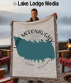 Man holding Lake McConaughy Nebraska map blanket with fringe, lake background.