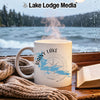 White mug with "Rainy Lake Minnesota" and compass design by a rainy window.