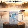 White mug with Chatuge Lake map and compass on a serene lake scene.