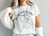 White t-shirt with "Burnsville Lake" and compass graphics, showing West Virginia outline.