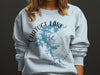 Light blue sweatshirt on a person with "Chatuge Lake," map, compass, and "North Carolina" text.