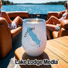 A white stainless steel wine tumbler with a Gull Lake map design sits on a boat table.