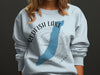 Light blue sweatshirt with Redfish Lake, Idaho graphic and compass rose.