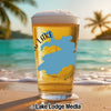 Beer glass with blue lake map graphic on tropical beach background.