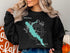 Black sweatshirt with a teal map of Lake San Pablo and compass graphic.