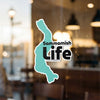 Aqua Sammamish Life sticker on a glass surface with blurred background.