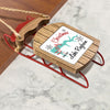 Wooden ornament on red sled with text "Merry Christmas From Lake Rayburn".