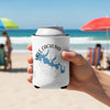 White drink koozie with Lake Cachuma map and compass graphic, held at the beach.