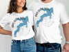 White t-shirts featuring a blue map of Arcadia Lake, Oklahoma with a compass graphic.