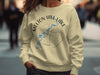 Light yellow sweatshirt with "Melton Hill Lake Tennessee" and compass graphic.