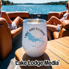 A white stemless wine tumbler with a Lake Kabetogama, Minnesota graphic rests on a boat table.