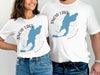 White t-shirts with blue Snow Lake Washington map and compass graphic.