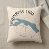 Cream pillow with "Rainbow Lake Maine" text and blue lake map over compass.