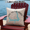 Light beige pillow with Lake Thunderbird map and compass design on red Adirondack chair.