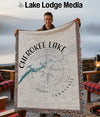 Man holds Cherokee Lake Tennessee map blanket with compass design.