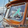 Teal lake outline sticker on boat window: Lakewood Life, Lake Lodge Media logo.