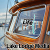 Kootenay Life sticker on a boat window with Lake Lodge Media logo.