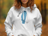 White hoodie with a blue outline of Idaho and "BLACK LAKE IDAHO" text.