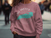 Rose pink sweatshirt with teal Lake America map and compass graphic.