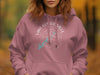 Pink hoodie with white text and turquoise lake graphic on chest.