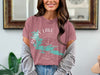 Dusty rose t-shirt with Rainy Lake map and compass design