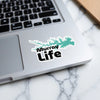 Sticker with turquoise lake outline and black text "Murray Life" on a laptop.