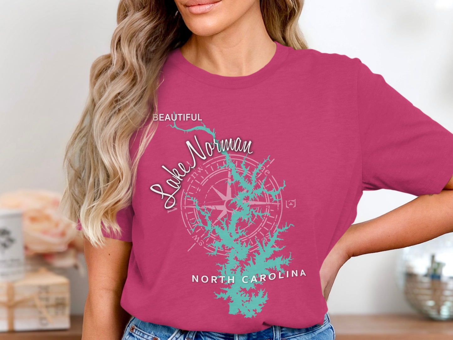 Woman wearing pink t-shirt with Lake Norman map and compass rose graphic.