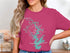 Woman wearing pink t-shirt with Lake Norman map and compass rose graphic.