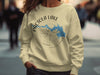 Cream sweatshirt with Pactola Lake South Dakota graphic and compass design.