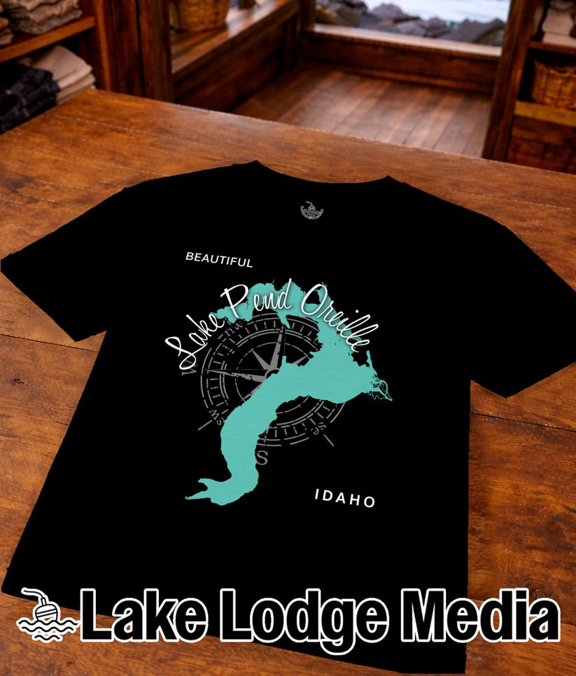 Black t-shirt with turquoise map and compass graphic, "Beautiful Lake Pend Oreille Idaho" text.