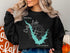 Black sweatshirt with "Beautiful Castaic Lake California" map and compass design.
