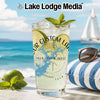 Glass of drink with lime and mint, "Lake Lodge Media" logo, and compass design.