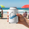 White koozie with Lake Erie map and compass design held on a beach.