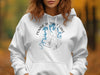 White hoodie with a compass design featuring blue lake graphic and "Pomme de Terre Lake Missouri" text.