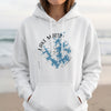 White hoodie with blue Lake Martin Alabama compass graphic and watermark.