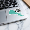 Turquoise sticker with black text reading "Clear Life" on a laptop.