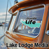 Oneida Life logo on a wooden boat with "Lake Lodge Media" text.
