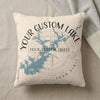 Cream pillow with blue lake outline, compass, and custom text.