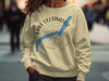 Light yellow sweatshirt with blue Lake Ullswater map on compass design.