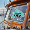 "Manawa Life" logo on a boat window, with "Lake Lodge Media" text below.
