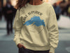 Yellow sweatshirt featuring a blue outline of Lake Superior and a compass graphic.