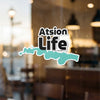 Atsion Life sticker with turquoise outline, on a window.